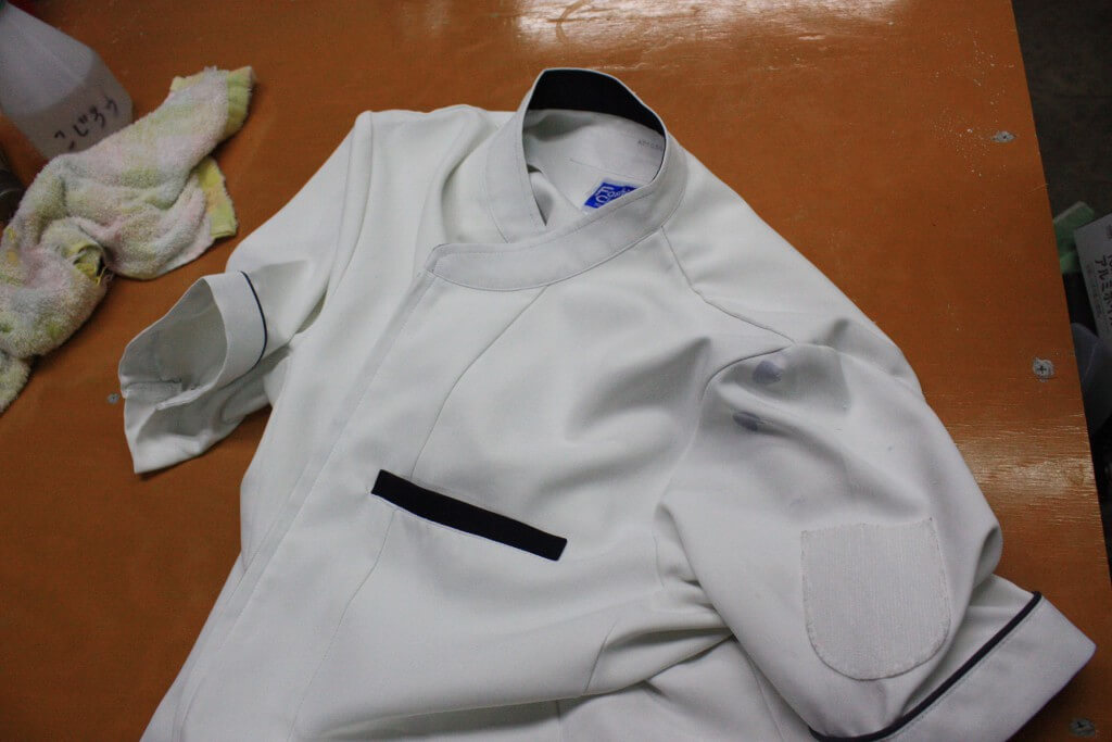 白衣の肩に付いたボールペンのインク